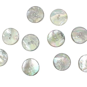 May include: Ten round, iridescent, mother-of-pearl buttons with two holes each.