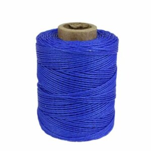 May include: A spool of bright blue waxed linen thread. The thread is wound tightly on a cardboard spool.