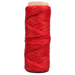 May include: A spool of red string, wound tightly and ready for use in crafts or other projects.