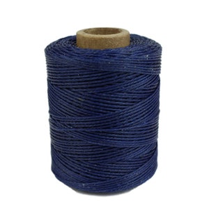 May include: A spool of dark blue waxed thread.