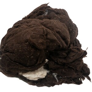 May include: A large clump of brown wool fibers, with some white fibers visible at the bottom.