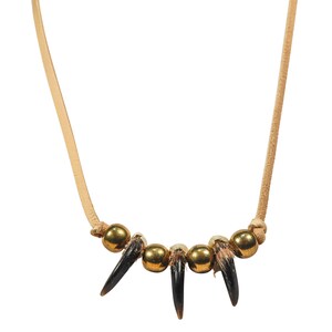 May include: A necklace made of brown leather cord with five gold beads and four black bear claws.