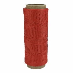 May include: A spool of red waxed thread for leather crafting.