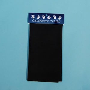 May include: A black fabric square with a blue header that says "Chichester Crafts" and has five white handprints.