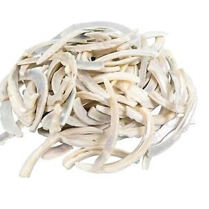 May include: A pile of white and iridescent mother of pearl shell pieces. The pieces are long and thin, and they are arranged in a random pattern.