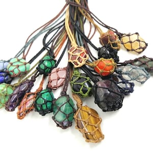 May include: A collection of colourful gemstone pendants, each encased in a knotted macrame net. The stones include amethyst, rose quartz, tiger's eye, and more.