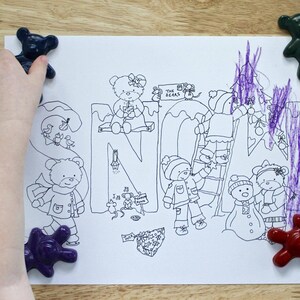 May include: A black and white coloring page with the word "SNOW" written in large letters. The page features illustrations of bears, a ladder, a Christmas tree, and other winter-themed imagery. The page is surrounded by colorful toy bears.