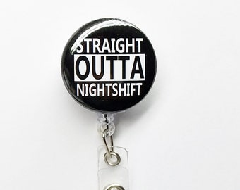 May include: Black and white button with the text "STRAIGHT OUTTA NIGHTSHIFT" attached to a clear plastic retractable badge holder.