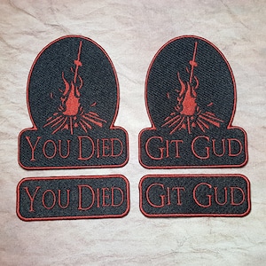 May include: Four black and red embroidered patches. Two patches feature a bonfire with a sword and the text "You Died". The other two patches feature a bonfire with a sword and the text "Git Gud".