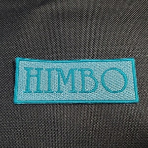 May include: A teal blue embroidered patch with the word "HIMBO" in white lettering.