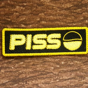 Bold and Playful &quot;Piss&quot; Soda Embroidered Patch - Unique Pop Culture Statement
