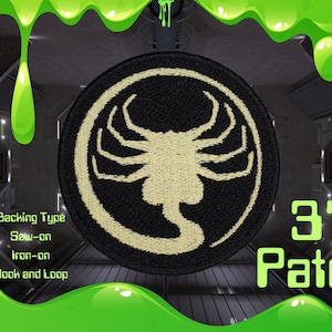 May include: A round, black patch featuring a cream-colored alien face design. The patch is 3 inches in diameter and has options for sew-on, iron-on, or hook and loop backing. The word "Patch" is written in green.