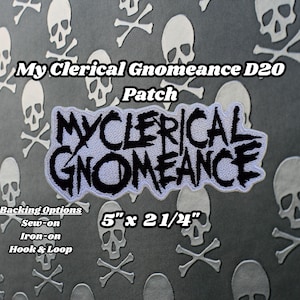 May include: White patch with black text that reads "My Clerical Gnomeance" with a skull and crossbones pattern background. The patch is 5 inches by 2 1/4 inches. Backing options include sew-on, iron-on, and hook and loop.