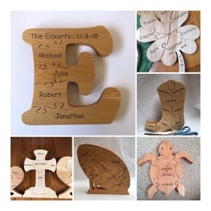 May include: A collection of wooden jigsaw puzzles featuring various shapes and designs. The puzzles are made of natural wood and have engraved names and dates. The puzzles include a cross, a boot, a turtle, a letter E, and a flower.
