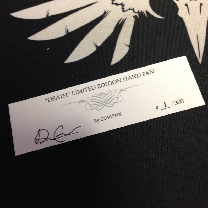 Paper card that is inserted into hand fan package that shows the limited edition numbering of 1/300. There is a signature from the artist, Denis Caron.