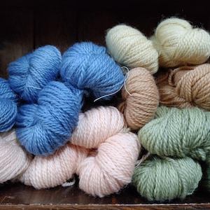 May include: A trio of ceramic mugs with a speckled, matte finish in cream, light grey, and dark grey. Each mug features a simple, minimalist design, ideal for tea or coffee.