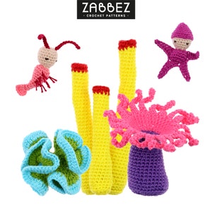 May include: A set of crocheted sea life amigurumi toys, including a pink and purple anemone, yellow coral, a blue and green coral, a pink shrimp, and a purple starfish. The toys are all handmade and have a whimsical, cartoonish style.