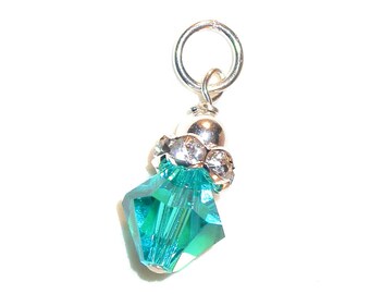 May include: A silver charm featuring a teal crystal pendant and clear rhinestones.