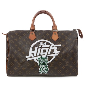 May include: A brown and tan Louis Vuitton handbag with a white and green "Get High" graphic and a green cat illustration.