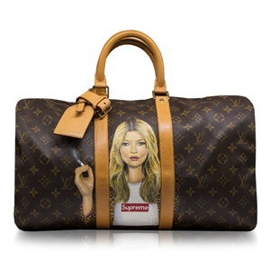 May include: A brown and tan Louis Vuitton travel bag with a painted image of a woman with blonde hair wearing a white shirt with the word "Supreme" printed on it. The woman is holding a cigarette in her right hand.