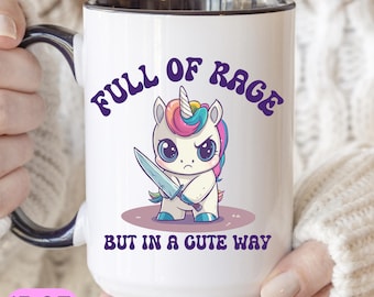 May include: White ceramic mug with a black interior and handle. The mug features a cartoon unicorn with a knife, the text "FULL OF RAGE BUT IN A CUTE WAY", and a 15 oz. capacity. The unicorn has a rainbow mane and horn.