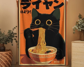 May include: Orange blanket featuring a black cat eating ramen from a bowl with chopsticks. The cat has large yellow eyes and is set against an orange background with Japanese text. The blanket has a vintage, cartoon-like style.
