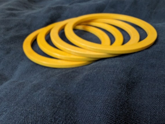 Four thin square edged yellow Bakelite bracelets.… - image 4