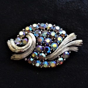 Oval metal brooch with deep blue/turquoise rhinestones.  Mid Century.