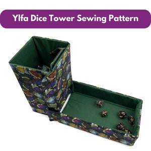 May include: A dice tower sewing pattern with a black and patterned exterior and green interior. The tower is open, revealing the interior and dice. The text "Ylfa Dice Tower Sewing Pattern" is displayed on a purple banner.