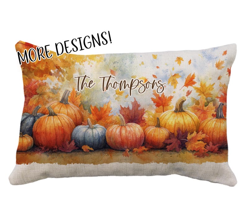 May include: Rectangular decorative pillow featuring a watercolor design of pumpkins and autumn leaves in shades of orange, yellow, and red. The text "The Thompsons" is written across the top. The pillow has a beige linen texture.