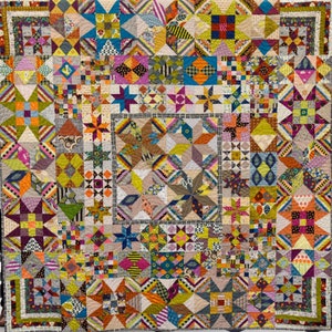May include: A colorful quilt with a patchwork design featuring various geometric shapes and patterns. The quilt is made up of many different fabrics in shades of blue, green, yellow, orange, red, and brown. The quilt is a great example of a traditional quilting style.