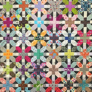 May include: A colorful quilt with a patchwork design featuring a variety of fabrics with different patterns and colors. The quilt is made up of squares with a cross shape in the center. The quilt is made with a variety of fabrics, including floral prints, geometric patterns, and solid colors. The quilt is a great example of a handmade quilt.
