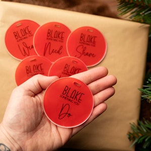 May include: Six red round gift tags with the text "BLAKE SOMETHING YOU" and a different word on each tag: "Want", "Need", "Share", "Do", "See", and "Get".