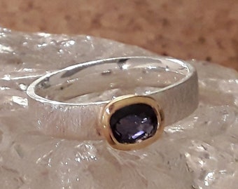 Silver ring with sapphire in gold frame / faceted