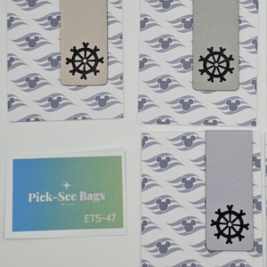 May include: Three rectangular magnetic bookmarks in silver, each featuring a black ship's wheel cutout with mouse-ear accents. The bookmarks are attached to white cards with a repeating pattern of purple mouse ears and waves. A small card reads Pick-See Bags ETS-47.