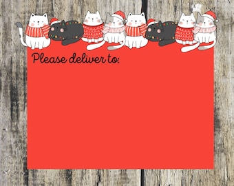 May include: A red card with the text "Please deliver to:" at the top. A row of nine cartoon cats wearing Santa hats and sweaters are at the top of the card.