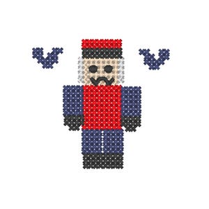May include: A cross-stitch pattern of a nutcracker figure wearing a red jacket, blue pants, and a red hat, with white hair and a black mustache. The figure is flanked by two small, dark blue, V-shaped decorative elements on either side.