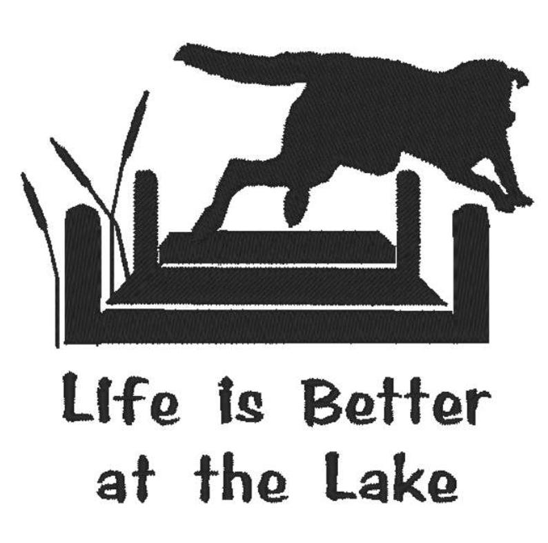 May include: Black silhouette of a dog jumping over a hurdle, with cattails on the left. The text "Life is Better at the Lake" is below the dog and hurdle.