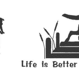 May include: Black and white graphic featuring a dog leaping over a dock with cattails. The text "Life is Better at the Lake" is below the image. The design is simple and suitable for lake-themed merchandise.