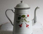 Vintage cream-coloured enamel coffee pot with flower decoration.