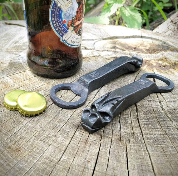 122 favorites and a dragon sculpted from solid steel by a blacksmith — this is miniature functional metalwork art, not just a bar tool.
