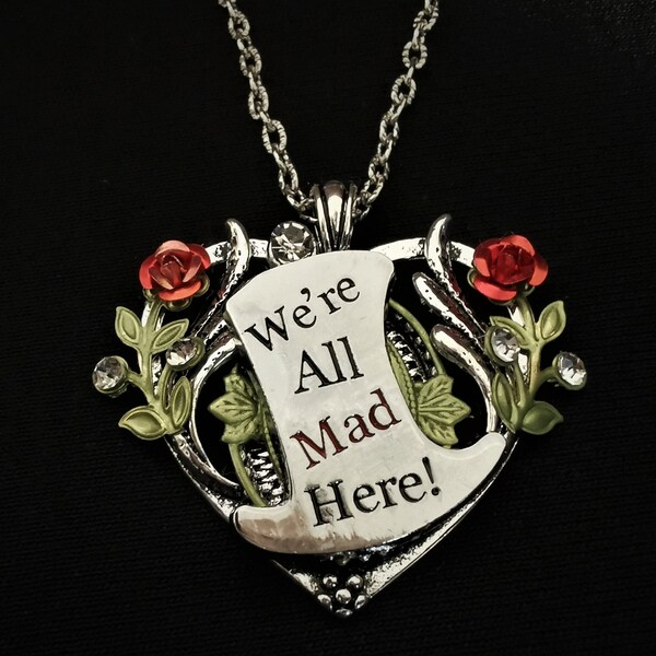 Hand-painted Alice in Wonderland-inspired heart-shaped pendant necklace with Mad Hatter-style top hat & the inscription We're All Mad Here!