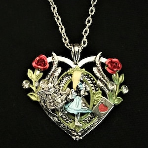 Hand-painted Alice in Wonderland-inspired heart-shaped pendant necklace with Alice, White Rabbit, and Ace of Hearts playing card charms