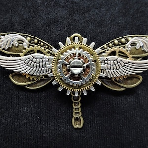 Steampunk Fantasy-themed Winged Bronze Dragonfly Pin Badge Brooch featuring gold, copper, and silver cogs, mechanical gears, & silver wings