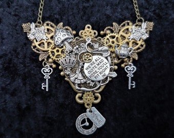 Alice in Wonderland-inspired Steampunk necklace including Alice, White Rabbit, Cheshire Cat, "We're all quite mad here", & "Drink Me" charms