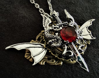 Beautiful Gothic Steampunk Goth pendant necklace with silver dragons, sword, and red crystal rhinestone and silver chain