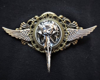 Steampunk Gothic Fantasy Winged Raven Bird Skull pin badge and brooch - featuring silver bird skull, wings and cogs and gears on bronze base