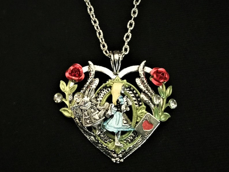 Hand-painted Alice in Wonderland-inspired heart-shaped pendant necklace with Alice, White Rabbit, and Ace of Hearts playing card charms 