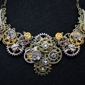 Beautiful Steampunk necklace with bronze, gold, copper, and silver gears, cogs, mini pocket watches and wings + rhinestone diamante crystals