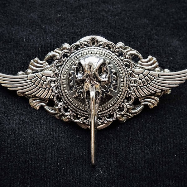 Gothic Steampunk Goth Fantasy Winged Raven Bird Skull pin badge and brooch with silver bird skull, silver wings, silver cogs and gears